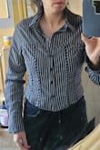 It's cute, but it is very tight.  No stretch at all.  It works for me even with it being so short, but I have a small bust. I would definitely go a size out two up, and the cut and design look really nice on me,  but I don't think it's for everyone. - Anna C.