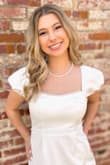 It was a little short and tight, but I love the pearl detail and puffy sleeves. Wore it for my grad photos - Em R.