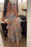 I received so many compliments on this dress!! It was slightly tight for me in the rib area but not to the point I was uncomfortable. I decided to tie the straps halter style instead of in bows to feel extra support without a bra and I really preferred how that looked on me! 10/10 dress!! - Erica Z.