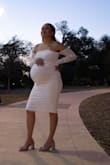 Used this dress for my maternity shoot. The fabric is perfect for the amount of give necessary for my 34 week pregnant belly! I'm petite and have a very "out there" bump, and it was super comfy. The sleeves were a dainty touch that really brought the look together. I was so happy with it. It is easily smudged, tho and the mesh makes it hard to come out in a pinch. My toddler got it smudged pretty quickly after the shoot started, but actually could mess with the folds in the mesh to hide it. If you're looking to accentuate your bump without the hassle of the flowy gowns (also just not my style), this dress is perfect!! - Amelia R.