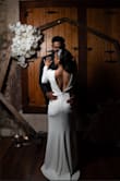 I wore this dress for my intimate ceremony and loved it. I decided to add a mesh panel to the front similar to another review I saw but left the deep V in the back. The only other alterations were hemming the dress and getting the shoulders taken up. Well worth it! - Lindsey T.