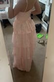 I LOVEEEE this dress so much I think it's the cutest thing however, I completely measured myself and read the chart which showed I was a size small but then once I tried it on it was a little too big even with the straps fully tightened (specifically around bust and waist) so I'm ordering it in a size down. The material is a little cheap feeling. But the color, pattern, style, and adjustable straps are perfect! Can't wait to wear this to prom. - Emma N.