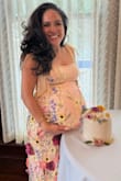I was nervous because the fabric is listed as not having a ton of give. I was 36 weeks pregnant at the time of my baby shower (9 months!), and it fit perfectly in all the right places. I was so happy. Got so many compliments, it really is stunning on, the pictures don't do it justice. Felt like I was in a custom couture dress lol. I sized up from my normal pre-pregnancy size (S), I'm petite, and the bump is pretty poked out in the front. The fabric and style in the front worked really well to accentuate my bump without having to tuck a hand under, so it doesn't look frumpy. A hand under the belly was cute too, and because it was maxi length on me, it didn't ride up too high over my ankles. No regrets buying this dress, very quality and no complaints at all. - Amelia R.