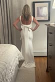 I read all the reviews on this dress before I decided to order it. Was happy to hear that most women loved it, so felt comfortable ordering from Lulus. After trying on 5 other dresses, this was the top choice. Material is stretchy, and loved how it fit my figure. I wanted simple, and this is it. Love the scoop back and the beautiful bow. Straps are slightly big, but nothing alterations can't fix. The length with heels will still have to be taken up just slightly. The only other idea I have is purchasing a bridal belt and having it sewn on the front seam. It will dress it up a little bit more and hide the seam line. Overall dress fits perfectly! Don't hesitate on ordering! Very happy with this dress! - Pamela O.