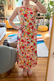 I really love this dress - so colorful and a fun back! I ordered my regular size M and it fits me well - that said I definitely have broad shoulders/back so I can see someone with small shoulders having the top run big. The dress is fully lined, but I didn't find the fabric too heavy - I think it's pretty light and flows well. I was hoping the back tie would cover a strapless bra, but it doesn't for me (at least without fabric tape/something to hold the bow in place). Overall, a great purchase for me and perfect for a summer wedding! - Summer V.