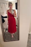The Never a Dull Moment Bright Red Tie-Strap Pleated Midi Dress is the perfect blend of simplicity and beauty. The design is minimal but makes a bold statement with its vibrant red color. It hangs beautifully on the body; so flattering on any shape, and the lightweight fabric feels soft and breezy, perfect for warm days or layering up on cooler nights.
The tie-straps are a lovely touch; not only do they add charm, but they make the dress easily adjustable for the perfect fit. I love how effortless it is to wear, and yet it looks so polished. Whether you're heading to brunch, a date night, or even a casual wedding, this dress fits the moment. I've already recommended it to friends, and I'd absolutely buy it again in other colors if available! - Corrie L.