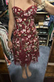 The embroidery on this dress is gorgeous. The red is much brighter in the daylight. The dress is fairly structured so it might not work for everyone, but was great for my proportions. My only complaint is the fabric in the back gaps at the bottom. - Megan K.
