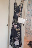 I bought this dress to wear as a wedding guest for a spring wedding. It arrived long, which was expected, based on other reviews. I had it hemmed about 1.5 inches. My tailor also added small breast cups in the top portion. This was helpful because most bras would not work with this dress. I have a very small chest, and this was all I needed. The straps adjust to fit, and the leg slit was perfect for keeping cool and walking around was a breeze. The flower pattern was gorgeous and I would recommend this for any spring/summer event. - Keris G.