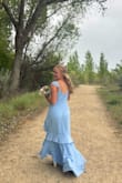 I thought the dress was great! Good quality, good arrival time, good fit. I'm shorter than the model, so it did hit longer, but my 3 inch heels made it the perfect length. It even rained during my pictures and the dress was not ruined because of it. - Jessica M.