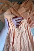The dress fit perfectly before I washed it. After putting it through a delicate cycle and a heatless tumble, the dress unfortunately had a large tear down the front of the dress. - Emily E.