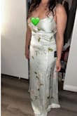 I wore this for my son's Vegas wedding. Extremely happy with my choice. The fit is absolutely perfect, hugging in all the right places. I purchased a medium for comfort, the picture with it long is a small. I attached the photo of it long and shorter. I had it altered to a shorter fit. The fabric  felt luxurious, and I received so many compliments. I highly recommend this dress. - Deserie C.