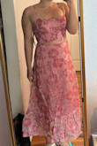 This two-piece was so beautiful. I tend to be in between a medium and large, with a smaller size on tops. I was able to make the top work for me after tying it pretty tight, but it would also definitely fit somebody with a larger bust. The waist of the skirt was the perfect size for sitting down and eating comfortably. It was also a great length for my height, with and without heels. The material doesn't have stretch, so I wouldn't recommend sizing down if you're in between. The dress looked beautiful without ironing, but be mindful of how you fold/ hang it up before wearing. Overall, I would definitely recommend this to someone my size or similar in the large - Erin M.