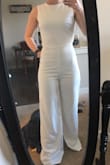 I am so in love with this jumpsuits and completely surprised how well it fits. I look forward to wearing it for my bridal shower and honeymoon. Fits true to size. Good length to be worn with heels, if you plan to wear flats you will probably need to get the pants taken in. Thick material, not see through. Just need to steam it and it'll be ready to go. - Paige K.