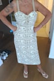 I love the length, the material, and color. The top fit me, but did not accent the bust area. I ended up cutting the strings that go around your neck and sewing each one for straps instead of tying into a halter style. It kept everything in place. Cute dress. - Michelle O.