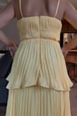 I wanted to love this dress so much. I bought to wear to a rehearsal dinner in July. It is an inch too high on either side in the bust even with a heavily padded bra. I am small chested, but it would fit DD. The pleating on the dress was also not even. One side was longer on both the bottom layers. The backing was also not sewed in even. One side was not pulled tight enough when sewn together. Both photos are taken after I took in 1.5 inches on both sides in the rib cadge. You can still see how the back right section has more fabric than the left. You can also see the middle layer  is longer on the left side. The bottom layer looks the same. Over all very sad the dress was made poorly & I would have retuned but I'm not willing to risk another dress looking like this or not getting here in time. - Taryn B.