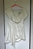 I have a natural, P-shaped figure and ordered a Large, hoping it would fit. Unfortunately, the dress wouldn't zip up at the top, so it didn't work for me. The zipper itself is also quite stiff and tricky to maneuver, you'll likely need someone to help you zip it up. I got this for a "white night" event on an upcoming cruise, but since it didn't fit, I had to order something else. The dress is beautiful and feels very elegant, but it has no stretch, so keep that in mind when choosing your size. If you're between sizes or have a fuller bust, you might want to size up or check the size chart carefully. Hope this helps! Pictured is with indoor light looks more ivory and natural light looks more white. - Ruth W.