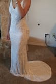 I'm not one to just spend money for the occasion. So, I didn't want to spend much on my wedding dress. I used a coupon and got this beautiful dress for $278. It's so sparkly, white, and does not look like it cost what it did. It fits really good. I ordered a size S, and I did have minor alterations because I'm not that busty in the chest. - Desirae M.