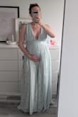 I simply love this dress; the fabric is lightweight and beautifully patterned, the split is present but not too obvious. I loved it even more because I was wearing it at 28 weeks pregnant and felt very pretty in it, which is hard to do in so many dresses (why do they take away so much coolness/sexiness in maternity clothes??) Anyway, I sized up to fit my belly and I did have the straps taken in by a tailor since they were a little loose (photo of me alone). The dress is on the longer side, I am 1.76m tall and wore shoes with just a small heel (about 3 cm). If you are also pregnant and want to wear a dress you feel beautiful and sexy in, try this one! - Iris H.