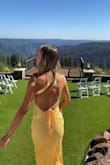 I LOVED this dress, and so did everyone else!! I got so many compliments on it. I wore it as a MOH dress for my sister's wedding.
It definitely took some practice tying the back, but it's easy once you figure it out. I'm on the tall side (5'9) and it hit me about mid shin. I will say it was a tad loose in the bust and would probably do better on people who have a little more going on there LOL. If I had more time, I would have gotten it altered, but it wasn't a huge deal. It also got pretty wrinkly throughout the night, especially after sitting down for dinner. But at that point, I had gotten all the pictures done so whatever.
Overall, beautiful dress :) - Katherine L.