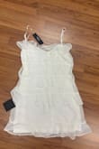 A small dress designed for a slim figure or a young girl. It is short in length, usually above the knee, and features a simple yet elegant design. Made of lightweight fabric, it offers comfort and style for casual or semi-formal occasions. The dress may include delicate details such as lace, ruffles, or a fitted waist. - Bibiana A.