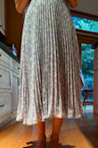 I fell in love with this dress when I first tried it on (the first pic). One of the straps broke, but my mom was able to fix it. I put it in my closet for future use, only to try it on again later and find that it was longer on one side (second attached pic) and also had bumps by the zipper. I'm so sad because it's such a pretty dress and nice length. - Siena P.