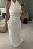 The color is white white vs. a soft white or ivory. The neckline and top part of the dress is very flattering but the bottom part is very bland, straight cut, no slit, back opening or anything. So the way it falls wasn't my favorite. Otherwise, beautiful dress - Karla T.