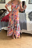Ordered and received quickly. Fit is true to size, material is light and flowy, and the one drop sleeve detail got lots of compliments! The ruffles and the red underskirt material really make it pop! Highly recommend this lovely dress! - Cathy K.