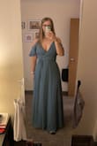 Super flattering dress, very comfortable, and color is great! The top fits a little loose, so be cognizant of that. The slit was nice (but can be dangerous if it's windy!). (First photo - out of the package, second photo - hemmed) - Karissa G.