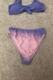 Would not recommend this at all. Nothing was wrong when I received the bathing suit. I washed it and the color was still fine. I wore this bathing suit to a pool for the first time this past weekend, and the bottoms changed color or lost the color. After I got out of the pool, my friend pointed it out to me and so it had to have happened while I was in the water. I wore other bathing suits in the same pool and this did not happen with them. I purchased the matching top, and it did not change color like the bottoms did, and I wore them together. I can't even wear this again and probably won't use the top much either, since it doesn't have the matching bottoms. It was a cute swimsuit otherwise.
Very disappointed with this purchase as I expected much better quality and got only one wear from it. It says that this isn't eligible for a refund so it feels like I wasted a good amount of money. - Hannah S.