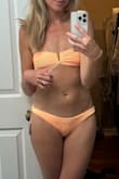 I felt like I was taking a chance buying this with no reviews on it, but it worked out great! It looked yellow in the pics, but since it said "orange" on the description, I took the chance, hoping it would be this orange color instead of yellow, and it was! Heads up, the matching bandeau top runs small!  Also, there is no padding in the top, but it still looks great, and I think it'll work well. My husband loved it the most out of all the ones I ordered. He said this is his favorite suit he's ever seen me in. :) For reference, I weigh 125 lbs- it wouldn't let me enter my weight! - Krista Q.