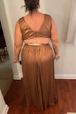 Ok please disregard the light green Spanx sticking out in the back picture but wanted to include it to show how the top closes- it is two buttons, NOT a zip closure up top. I was pleasantly surprised at how much less revealing I expected this dress to be when I tried it on, and the copper color truly is to die for. However, it does run really large and is SO long on me (I'm 5'9) so I would need to wear heels, and as much as I'm in love with this dress, she is going back. TBD on if I'll exchange for a smaller size or not, but I wanted to post a review mostly to show it's not as crazy revealing with the cutouts as the model pictures might indicate :) (even while dancing lol) - Allie M.
