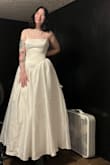I will admit that I was nervous buying a wedding dress that I had never tried on, and there were only two review photos. However, because of the sale, I decided to give it a shot. When it arrived, I tried it on immediately. Obviously, it will need to be steamed because it was inside of a box, and despite the fact that it needs to be taken in a little bit in the body. (Thus why I'm holding it back) It's absolutely perfect and it has pockets. It is heavy, but the material feels nice. (Excuse my dirty fan behind me lol) - September B.