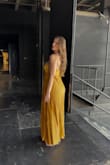 I was 5.5 months pregnant when I purchased this gown for the end-of-season concert at my opera summer festival. I had grown out of all my gowns and was looking for a bandeau-topped gown to disguise my bump. I felt so pretty in this golden color, which really caught the light on stage. Really low-maintenance fabric too, as I bundled it in my bag and did not have to iron upon taking it out. Highly recommend, especially for wide-shouldered/defined collarbones ladies. - Mary B.