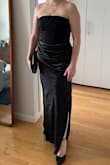 I bought this dress for a black tie wedding, and it was perfect. So figure flattering! I do have a smaller chest, so I'm not sure how comfy it would be if you had more going on, but the top has some decent stretch. The draping in the front is perfect for covering up any bloat and the dress hits right at the ground, so I didn't need to get it tailored, which was a nice surprise. Really a 10/10 dress. - Elizabeth B.