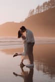 This was the dress I wore for my engagement shoot, and it truly couldn't have been more perfect for the moment. The soft cream knit felt timeless and elegant, and it matched the golden glow of the sunset in the most dreamy way. I loved how the long, simple silhouette looked against the beach backdrop, effortless but still so special. The removable sweater gave it a romantic touch that made me feel both cozy and beautiful.

The neckline is slightly frayed, which I noticed, but honestly, it didn't take away from how perfect the dress felt in that moment. It was everything I wanted. It's comfortable, elegant, and the kind of piece that lets me be fully present in one of the happiest memories of my life. - Ciera K.