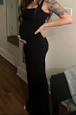 I sized down for a more snug fit. The XS fits well over my 17-week pregnant belly. Perfect length. A little see-through and thin, but didn't require a bra. I had to trim some loose strings, but overall, it worked well for the Black Tie wedding I attended. Preferred the straps up. - Megan D.