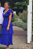 This dress was beautifully made and feels great on! The fabric does wrinkle easily, but due to all the pleats and ruffles, you can barely tell! The color is amazing and was great for the semi formal afternoon wedding I went to. It is very lowcut, so I needed to wear a low cut bra. I got so many compliments on this dress! Such a great purchase! - Summer C.