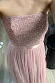 This dress looks exactly like the pictures. The sequins are well made and the color is a light pink. The length fits perfectly for me, and doesn't need alterations. I'm usually a size 2 in dresses, and the xsmall was too tight, but the small fit perfectly. - Sara B.