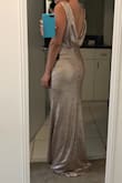 I ordered a S size and fits me perfectly. I think in pictures in lulus the dress shines more than in person. It is beautiful though. 
The only issue that I have with the dress is the length. It wasn't made for a 5"1 girl, not even if I wear high heels. Unfortunately, it will be returned. I don't want to end up on the floor. If you are taller than me, you will not be disappointed. - Angela D.
