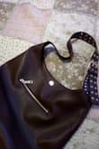 I bought this bag for everyday use. I carry around a lot.. Firstly, it is beautifully made and looks like real leather. When I first received it, it smelled like plastic, but it airs out quickly. I find this bag fits all my stuff and matches most outfits. Highly recommend! - Hannah B.