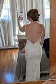 The open back is beautiful!! This dress fit me so well, but I would have to get the straps adjusted as they were falling down. The beading is beautiful, and it didn't rub against the inside of my arms! - Kaitlynn W.