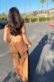 Bought this dress for a 70s theme wedding. The material is super luxurious, and it was really comfortable as well. I would size down. I'm 5'5 and 115 lbs, and ordered an XXS. The material is stretchy, so it looks really flattering when it's more fitted to the body. - Reina N.