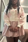 I love this outfit very much. I bought a size XL and I think it fits perfectly especially if you have a larger bust area. I paired it with the pink skort also from lulus. The sweater is very soft and warm. - Christine N.