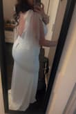 This dress fits true to size, an XL. It hugged every curve I wanted it to hug and hid every roll I wanted it to hide. I was actually pleasantly surprised to see it fit so well. It will need absolutely no alterations and fit like a glove. I truly saw myself as a bride when I put this on. - Mackenzie L.