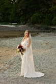 I purchased this dress for my micro wedding on the beach, and it turned out to be the perfect choice! The buttons add a chic, timeless touch, and I paired it with a lace veil that beautifully elevated the simple elegance of the gown. I would recommend sizing up, as I bought a medium, which is my usual size, but the waist runs a bit small, and I needed to have it tailored for the best fit. I had the straps adjusted and the hem shortened, and once altered, it fit like a dream. I didn't need to wear a bra, which was a pleasant surprise! Overall, I was so impressed with the quality, comfort, and look of this dress. It's especially flattering for women with a fuller bust or hourglass shape. - Kira C.