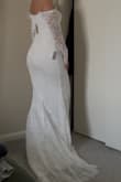 It fits so beautifully. It's a very romantic dress perfect for my Maui elopement! If you're thinking about it, get it! You won't be disappointed. Yes, the arm mobility is a little limited, but worth it. I am around 5'2 130 lbs, and it fits nicely! - Diana R.