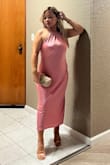I wore this dress for a Friendsgiving dinner with my girlfriends and overall I loved it! The size medium fit me comfortably, it wasn't super fitted, but it draped really nicely and felt easy to move in all night.
The only issue I had was the bust area. Both sides of the top were a little loose on me, so it didn't sit as snug as I wanted. I ended up using double-sided fashion tape, and it solved the problem perfectly. After that, the dress looked amazing and stayed in place the whole night.
The pink satin color is even prettier in person, very soft and feminine, and the halter neckline + open back makes it feel classy but still a little sexy. The length is great for petites too, it hit me mid-calf.
Super comfy, super cute, and definitely a dress I'd wear again. Just be ready to use a little tape if you're smaller on top or want a more secure fit! - Jochelle R.