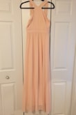 This dress was a little see through in the back and was a little long. I took up the straps and wore super high heels and that worked. It is also more peach than pink. My first picture of it hanging on the door is the actual color of the dress in person. But this dress is super comfortable super light and easy to dance in. I would recommend this dress to anyone! - Monica V.