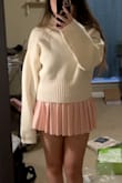 This is a really cute oversized sweater for fall/winter. I like pairing it with a skirt, either untucked or tucked. The ribbing at the bottom makes folding it under for a tuck very easy. The design on the front is very appealing, and the sweater isn't scratchy! Though I still wear a white tank top underneath. Couple caveats, I am pretty petite, and the mock neck is kinda tall, so sometimes I actually fold it over into a turtleneck. The sleeves are also very long, which is probably part of the style of winter sweaters. - Elizabeth F.