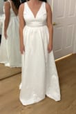 The item details say the bow is detachable. Although it is detachable, you cannot wear it without the bow as the snaps are still visible on the back. 

This dress is very poor quality and i would not recommend anyone order it. I was very surprised that Lulus would even sell this item. Save your time & money. - MaryKate C.
